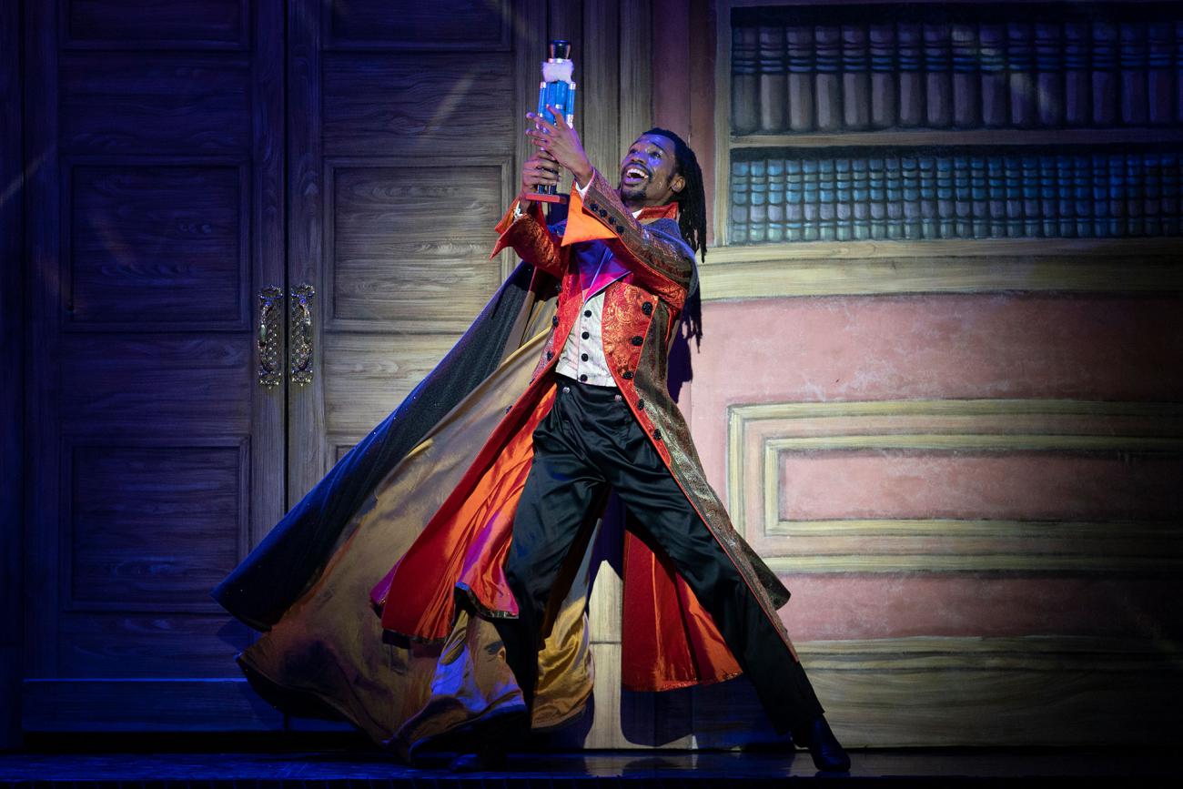 Uncle Drosselmeyer holds the toy nutcracker high