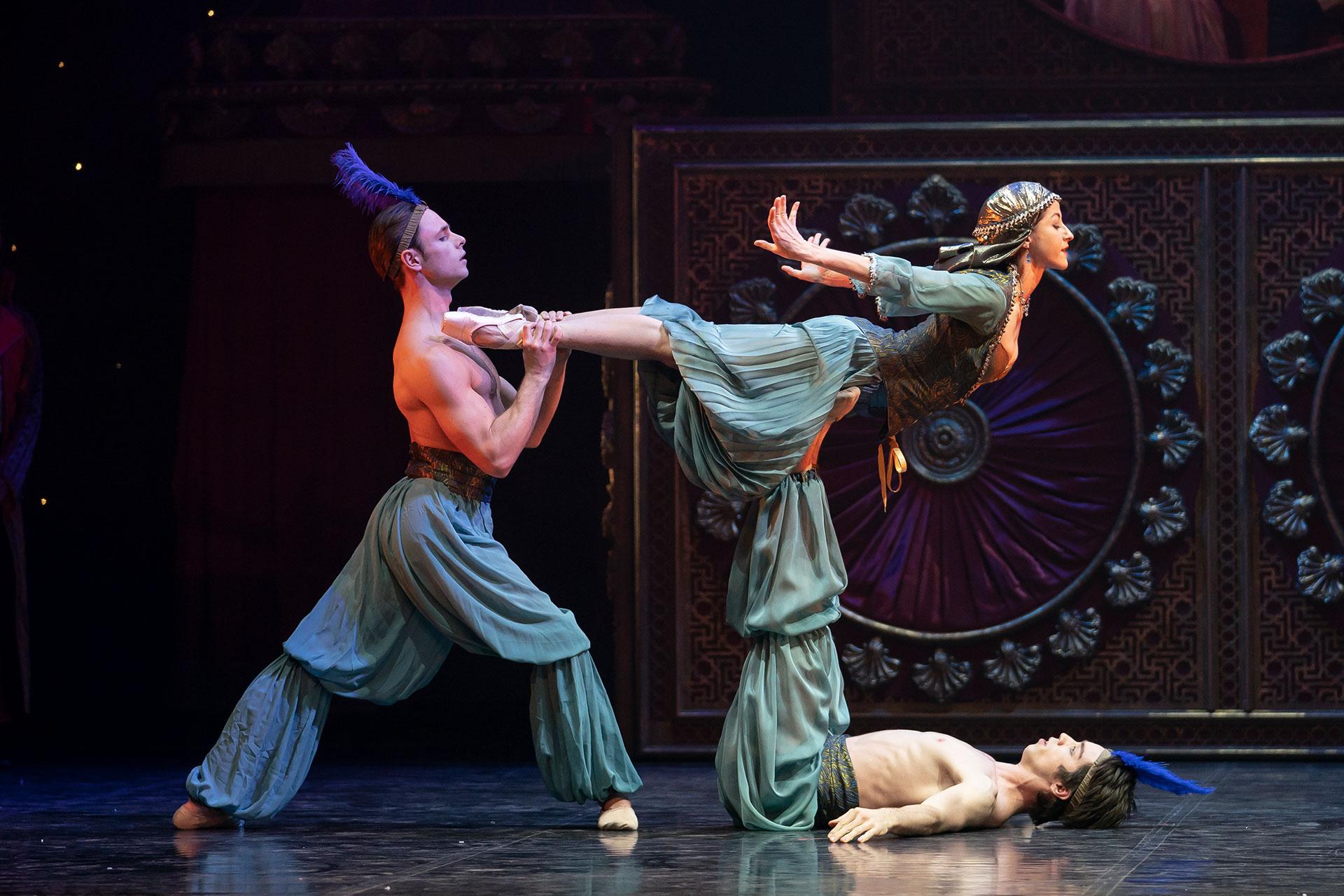 Gavin McCaig holds Nina Queiroz da Silva's feet as Adam Ashcroft holds her aloft with his feet