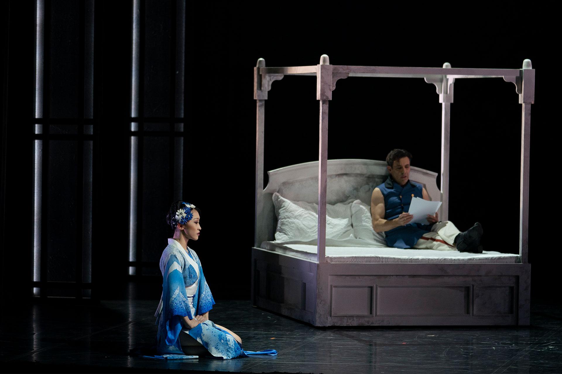 Townsend Harris reads in bed while Okichi awaits her duties.