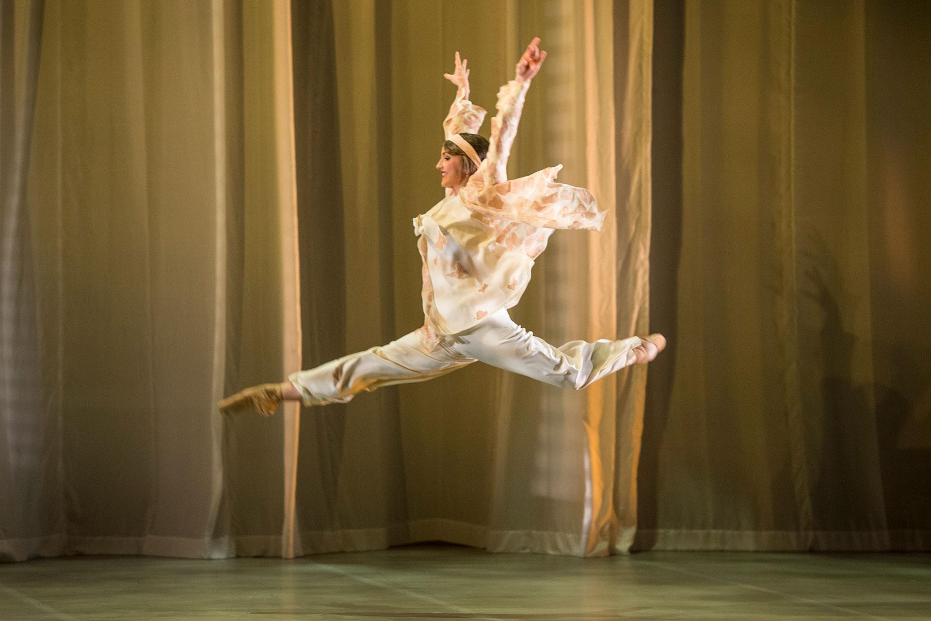 Jordan jump in a grand jete with her arms high