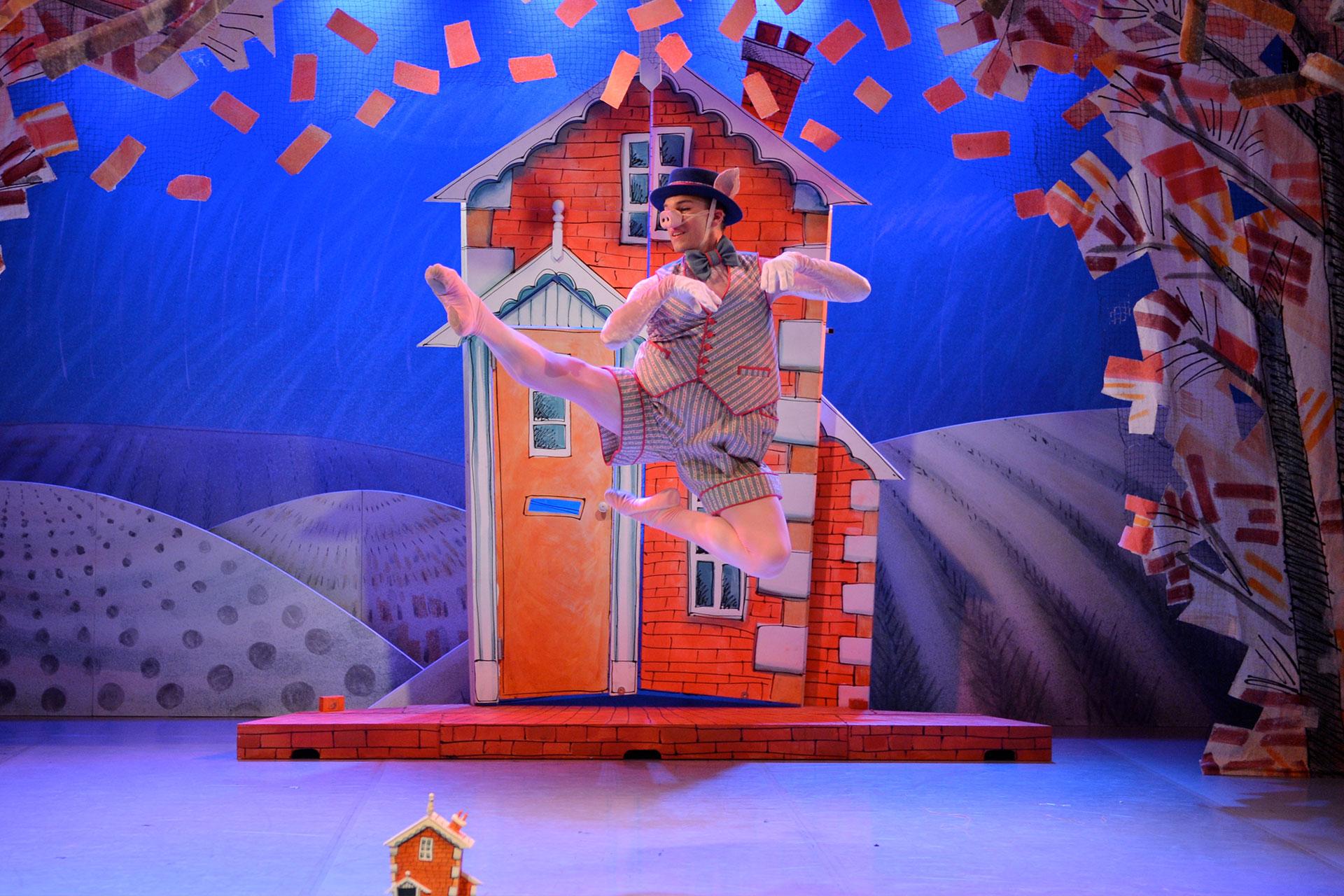 Brick Pig proudly dances in front of his secure home