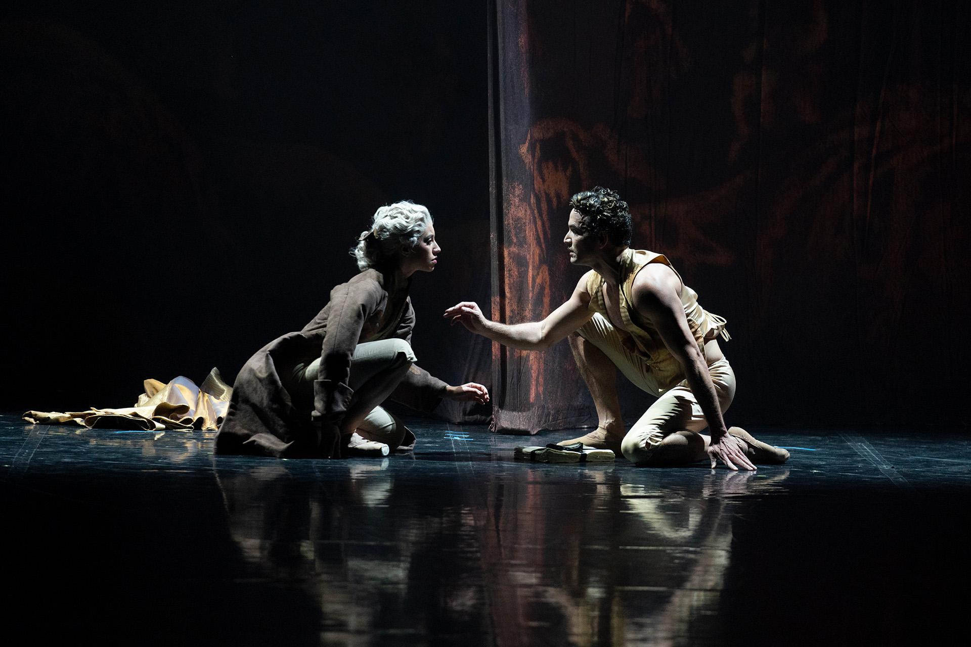 Henriette tentatively reaches towards a kneeling Casanova