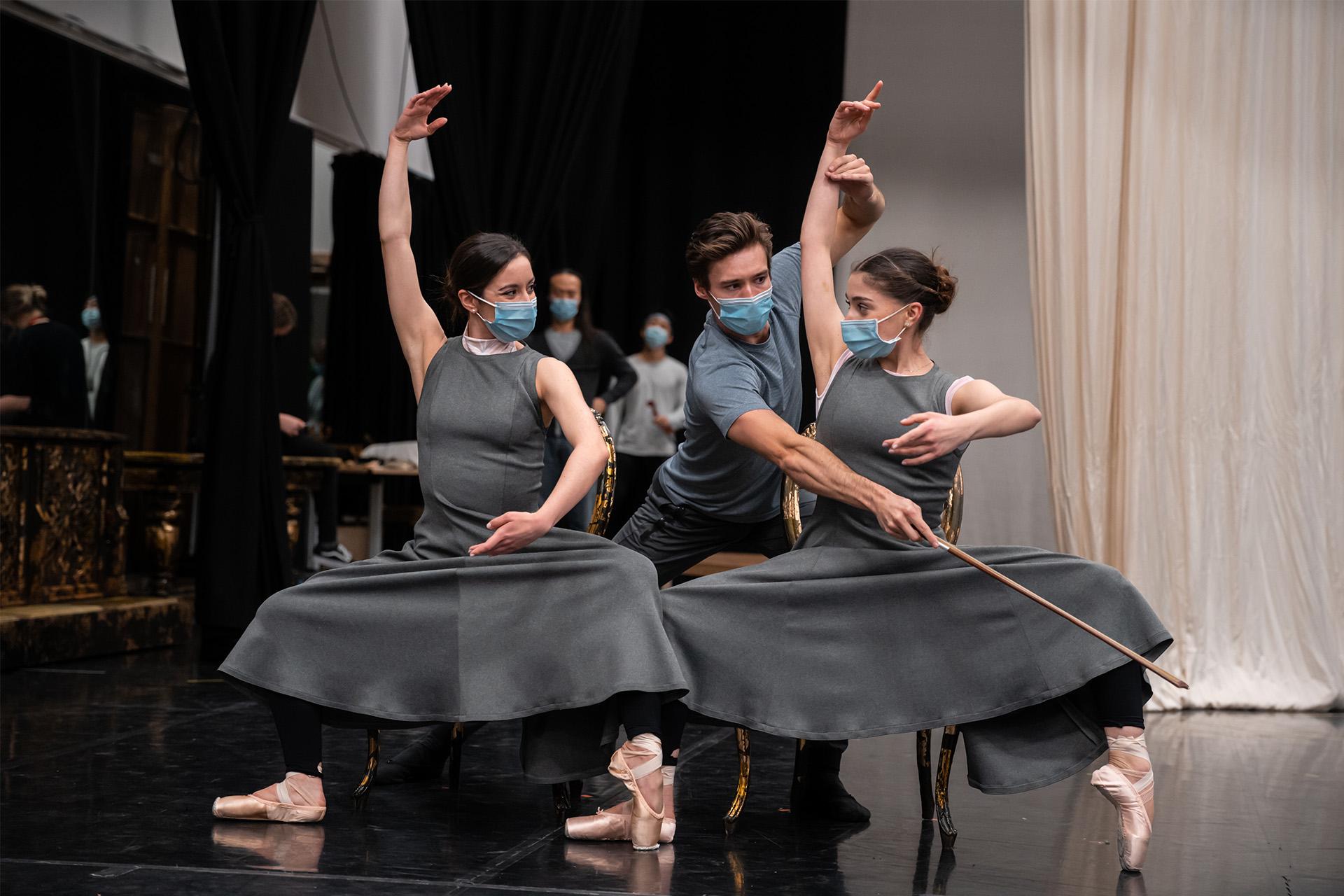 Dancer rehearsing as Casanova plays dancers posing as a musical instrument