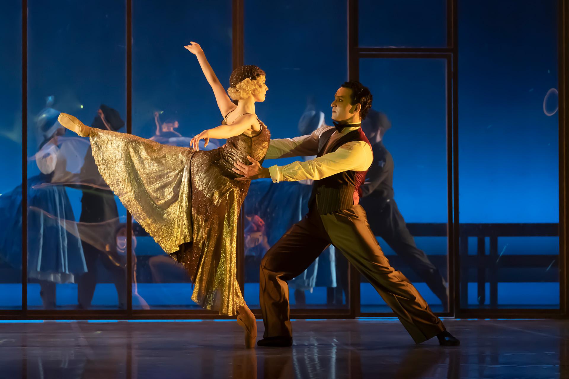 Gatsby holding on to Daisy and her looking lovingly at him