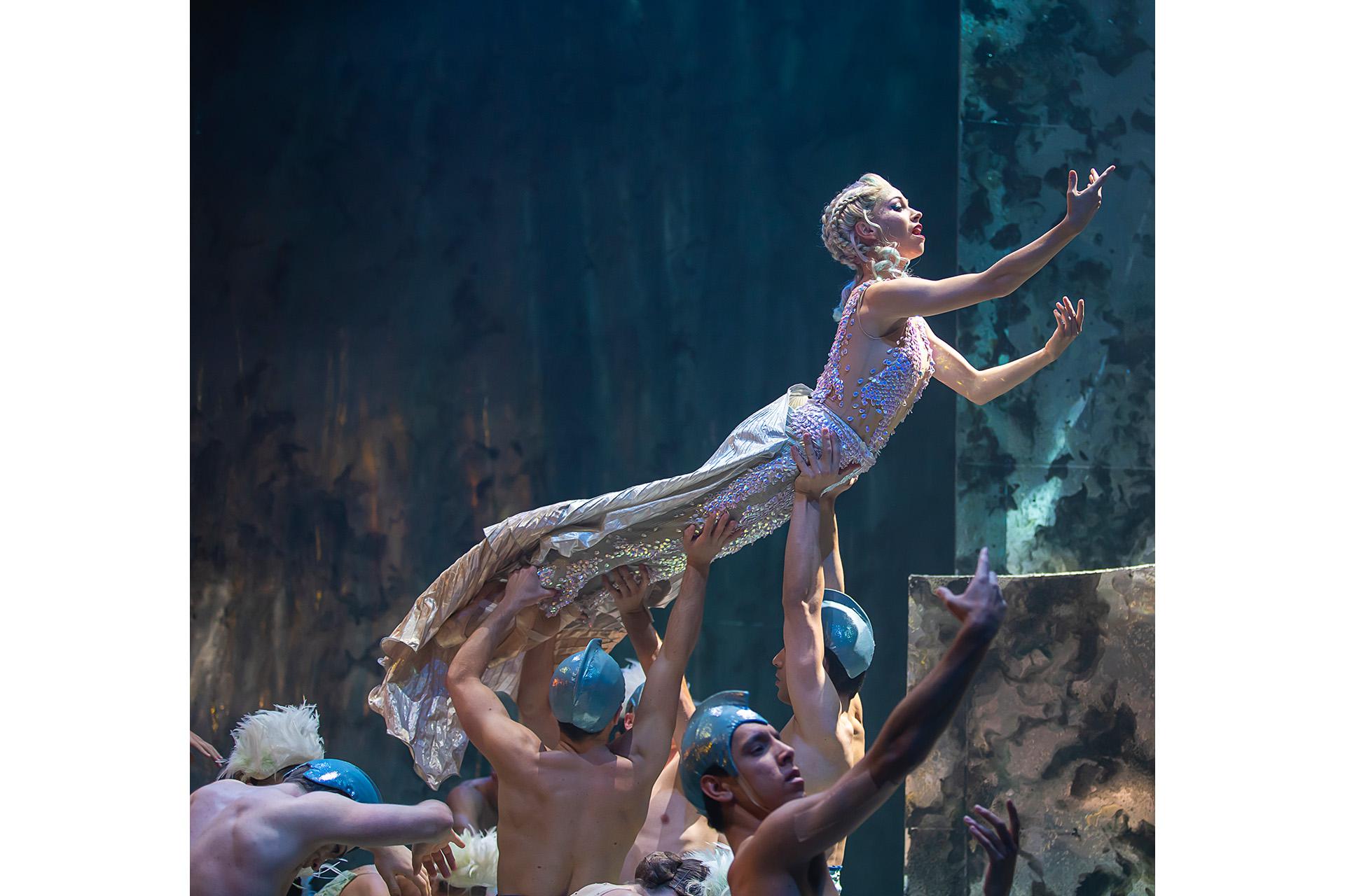 Marilla held aloft while singing demonstratively