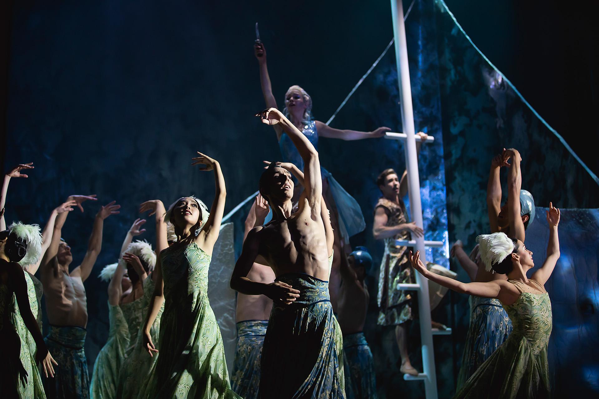 Dressed in blue and greens, Northern Ballet dancers represent the sea by moving in concert and against one another