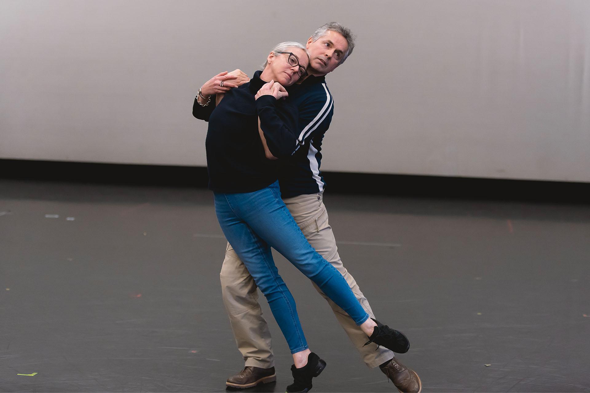 Jayne Regan Pink and William Walker, the original Romeo &amp; Juliet in this production, demonstrate choreography to dancers unseen in the image
