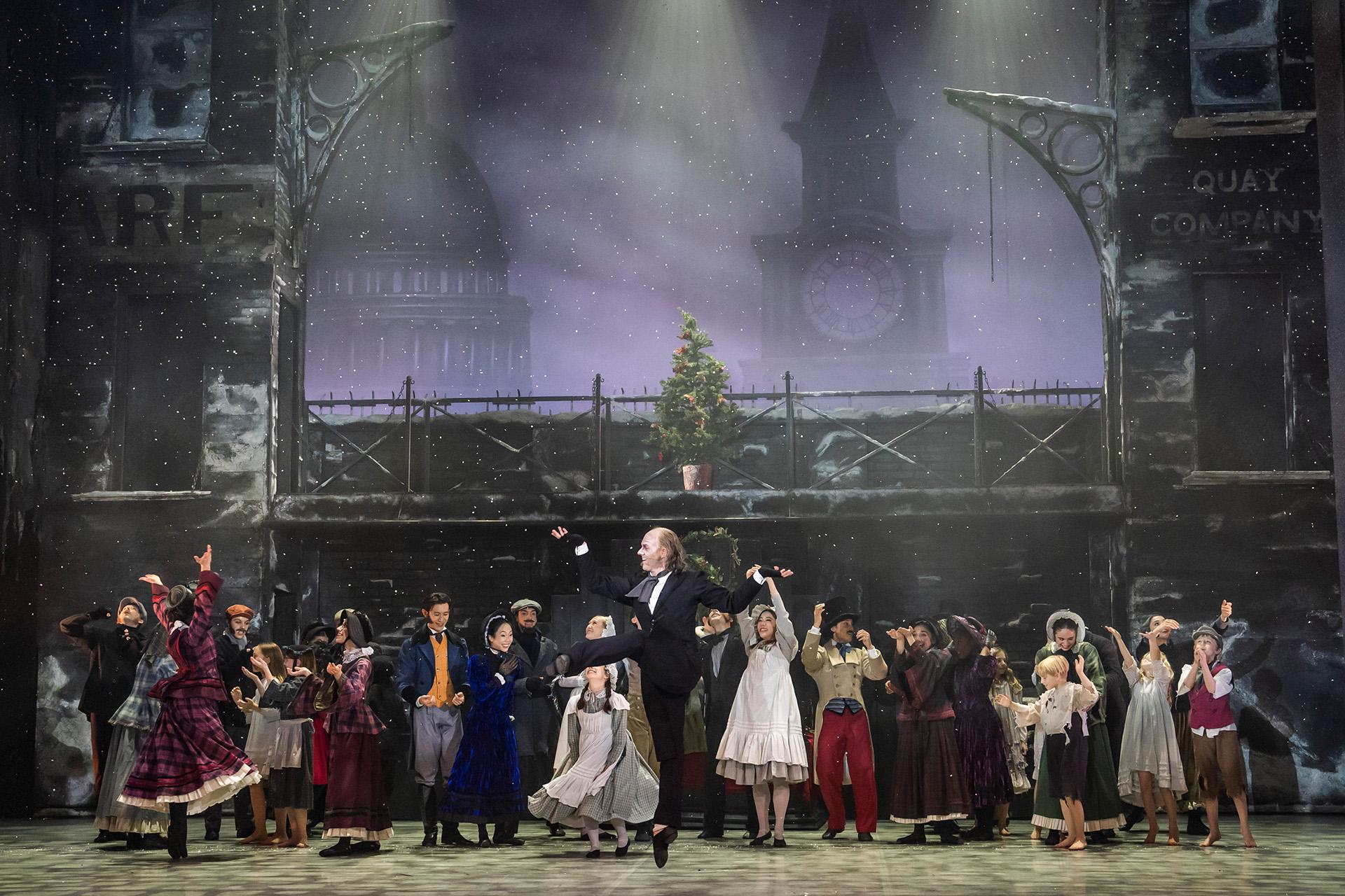 A dancer on stage jumping up in joy