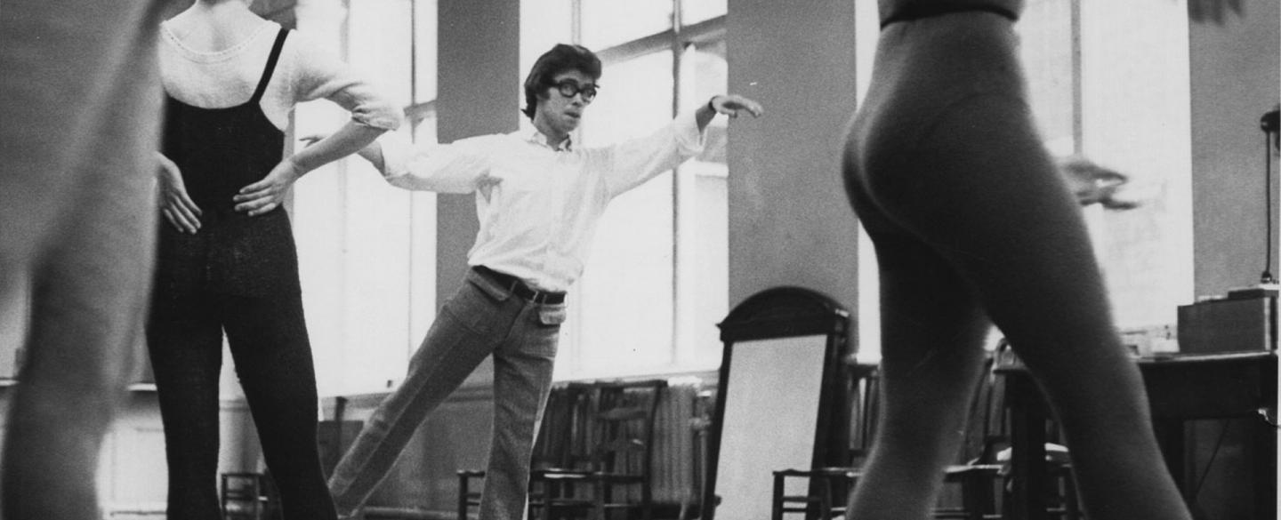 Laverne Meyer demonstrates a dance move to a full rehearsal room