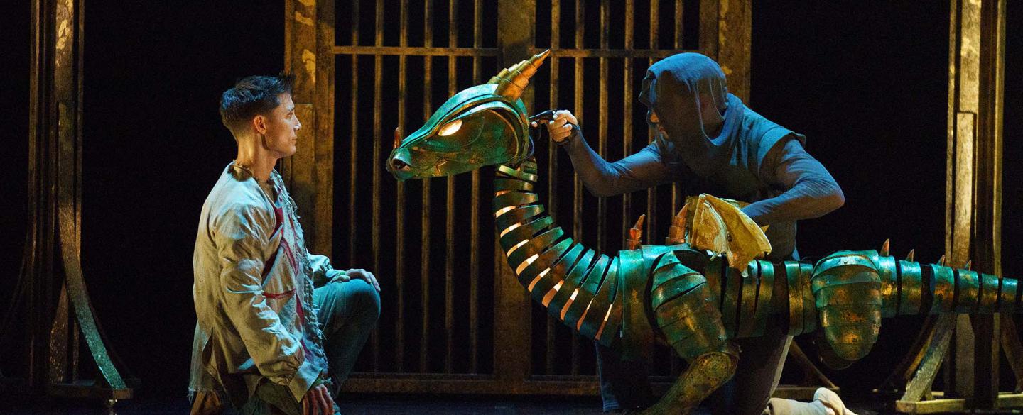 The dragon looks at Merlin, assessing him