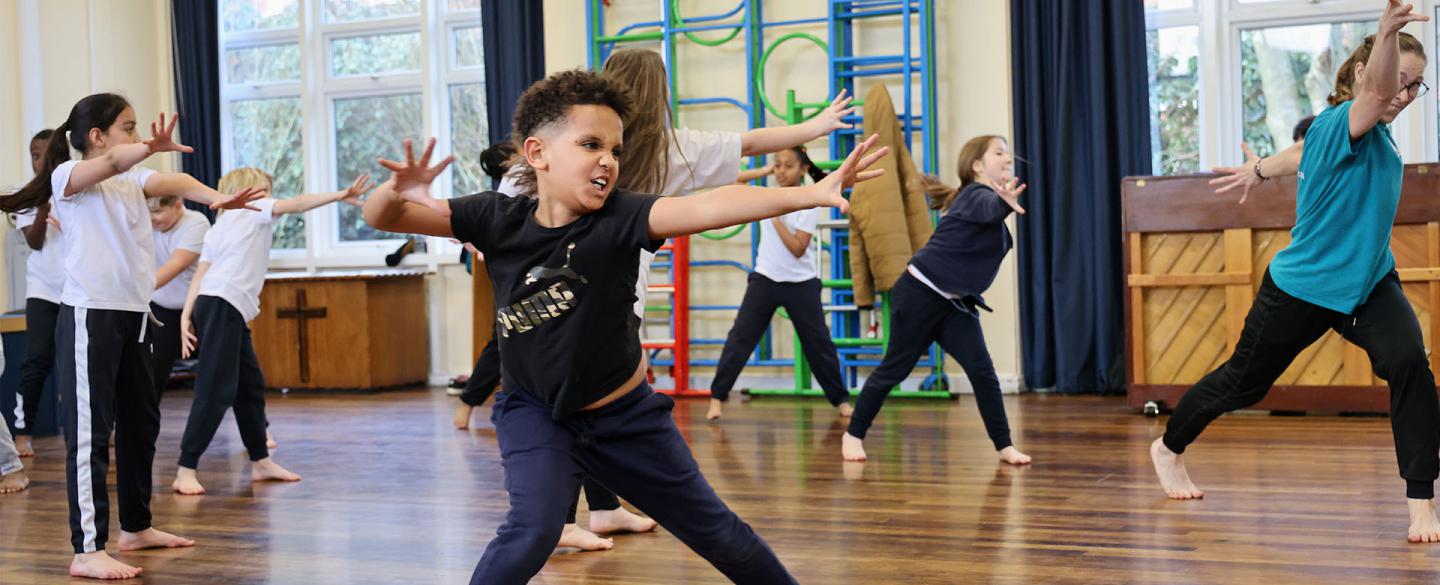 Boy in school hall expressing himself through dance