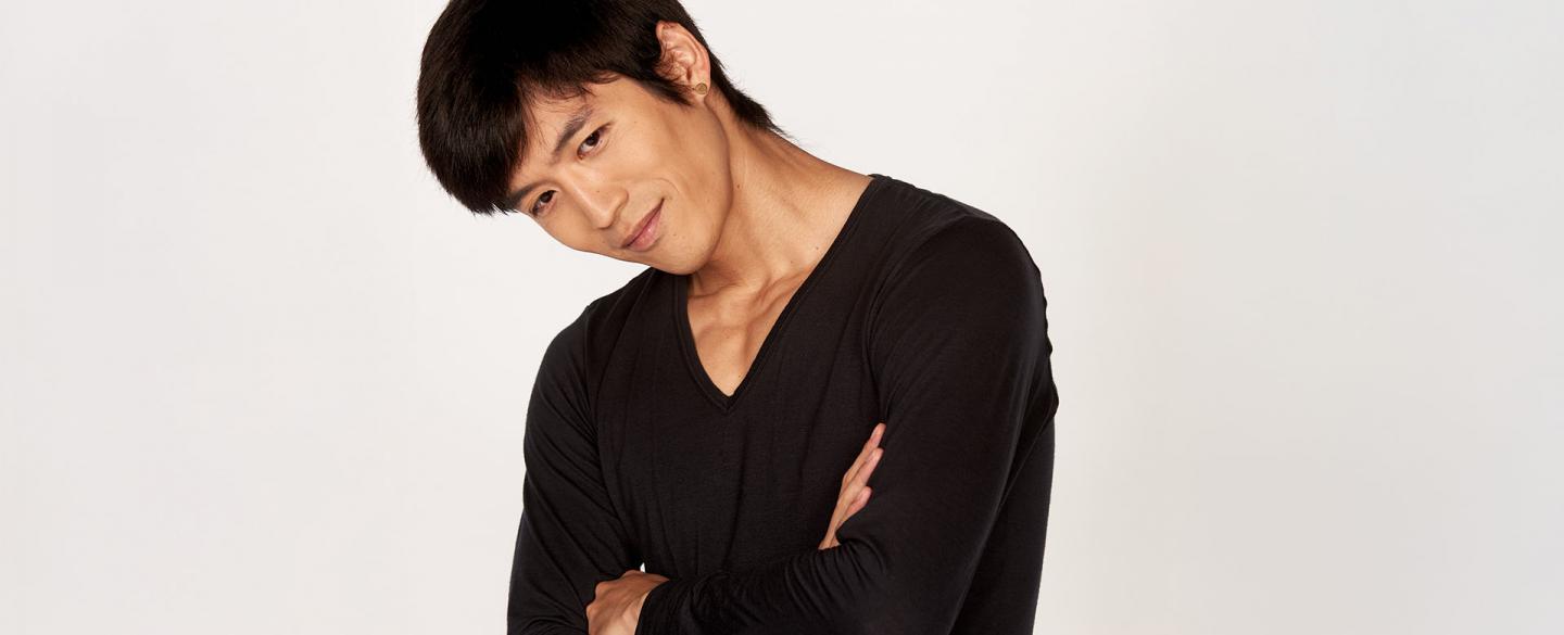 Yosuke Mino publicity photo of him wearing a black top and his arms folded