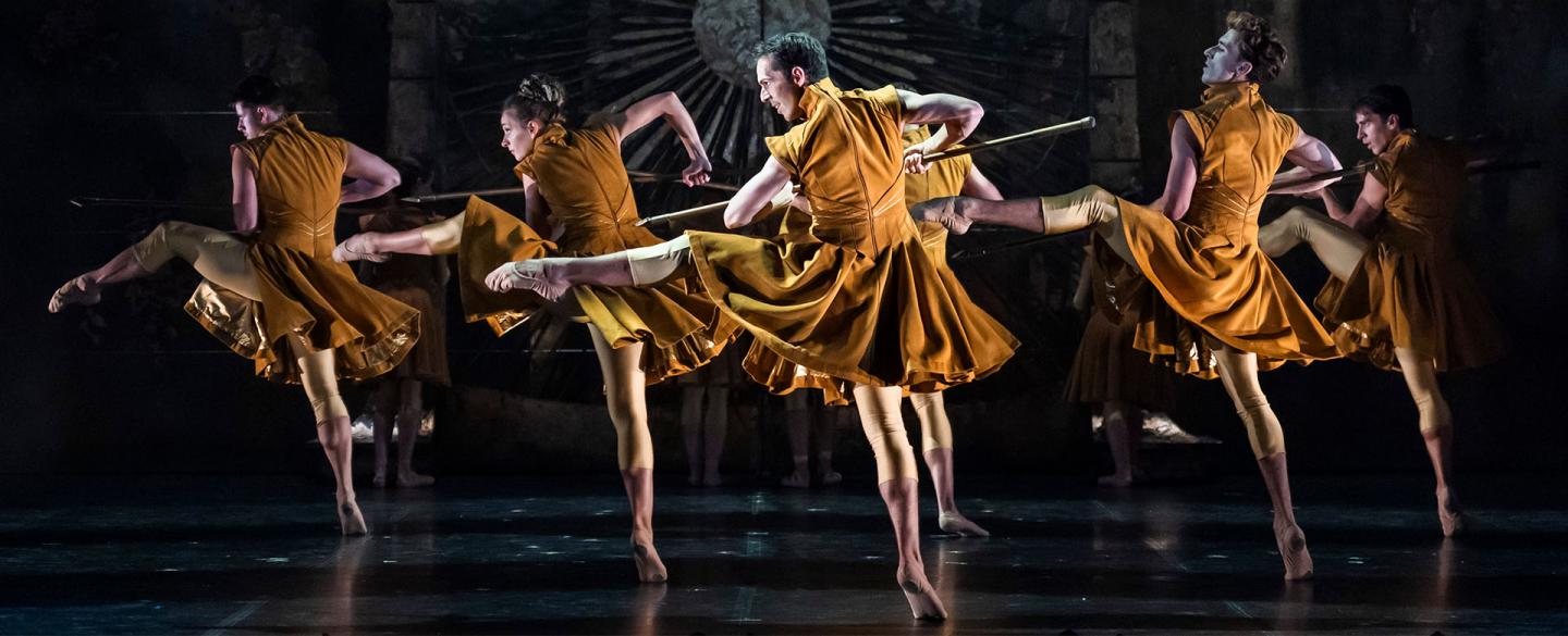 Army in gold velvet uniforms wielding pikes aggressively