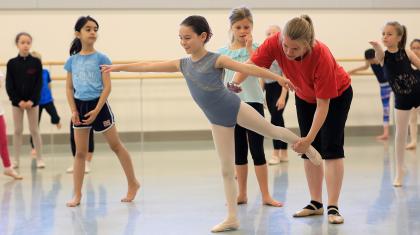 teacher coaching child on dance position