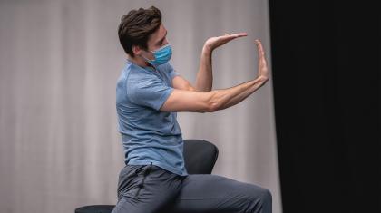 Dancer holding his arms in a stylised pose