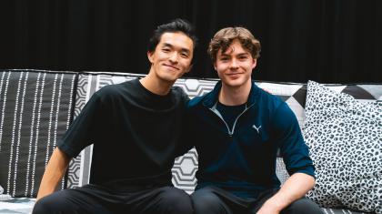 The two choreographers of Hansel & Gretel, George Liang and Harris Beattie, sat on the sofa that features in the ballet, both smiling directly at the camera