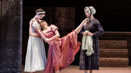 Jane in white hugs with Adele in pink, but very happy as a stern Mrs Fairfax looks on