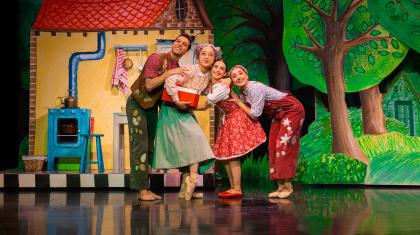 Little Red's family: father, mother, grandmother and little red hug each other happily